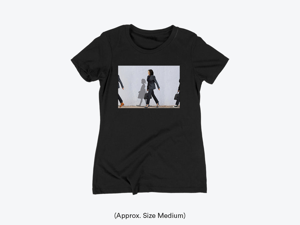 A black fitted tee with a graphic print of Harris Kamala and a girl shadow walking.